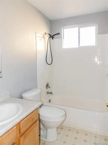 a bathroom with a toilet sink and shower