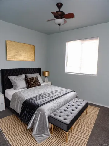 a bedroom with bed and wooden floor