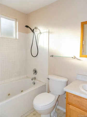 a white toilet sitting next to a bath tub