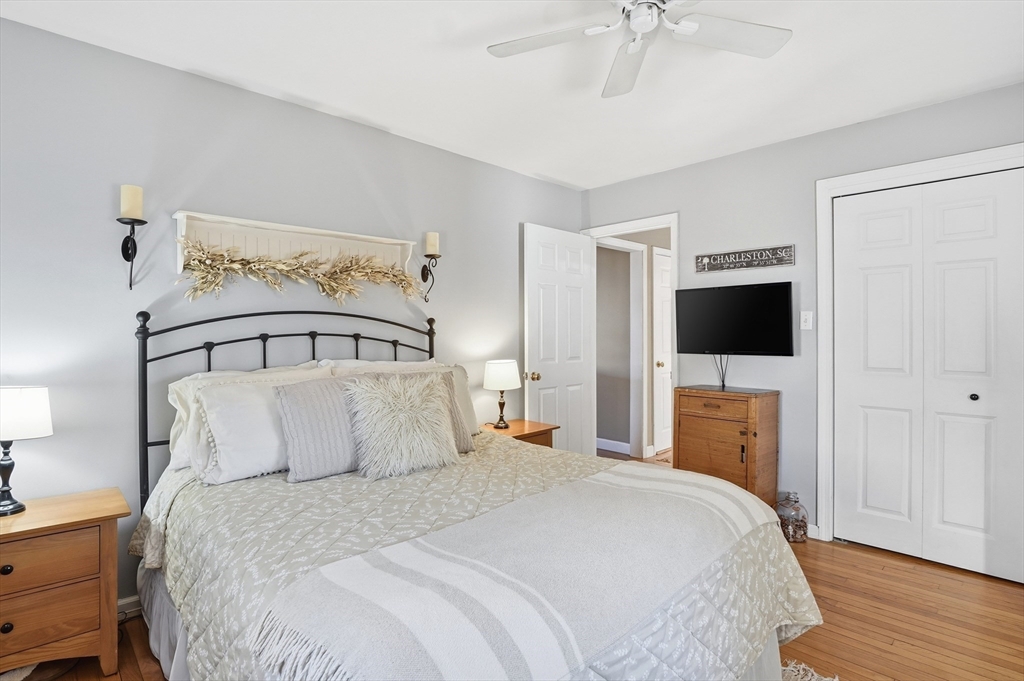 28 Sylvester Road Natick, MA 01760 - Photo 14 of 30 a bedroom with a bed and a flat tv screen on dresser