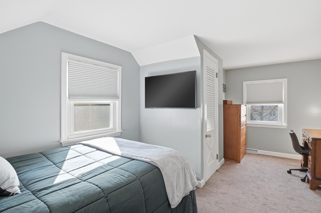 28 Sylvester Road Natick, MA 01760 - Photo 17 of 30 a bedroom with a bed and a flat screen tv