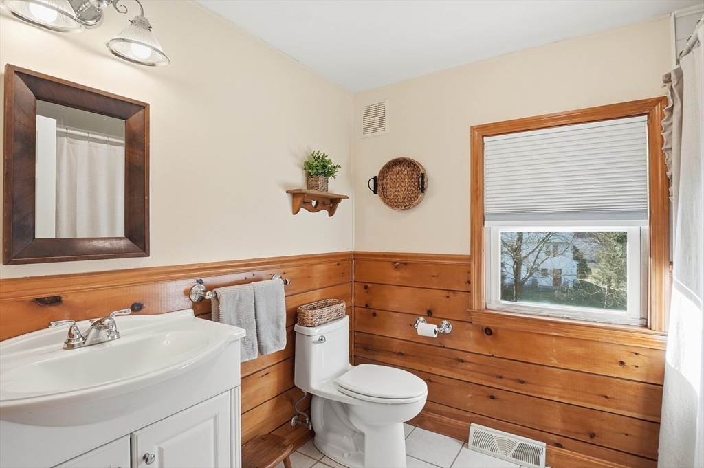 28 Sylvester Road Natick, MA 01760 - Photo 21 of 30 a bathroom with a sink a toilet and a mirror
