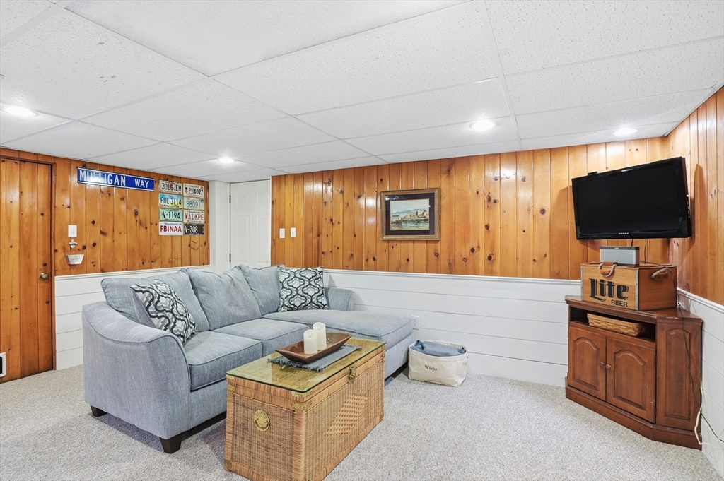28 Sylvester Road Natick, MA 01760 - Photo 24 of 30 a living room with furniture and a flat screen tv