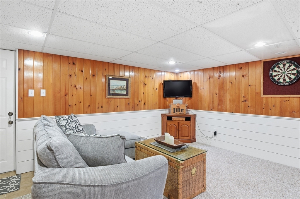 28 Sylvester Road Natick, MA 01760 - Photo 25 of 30 a living room with furniture and a flat screen tv