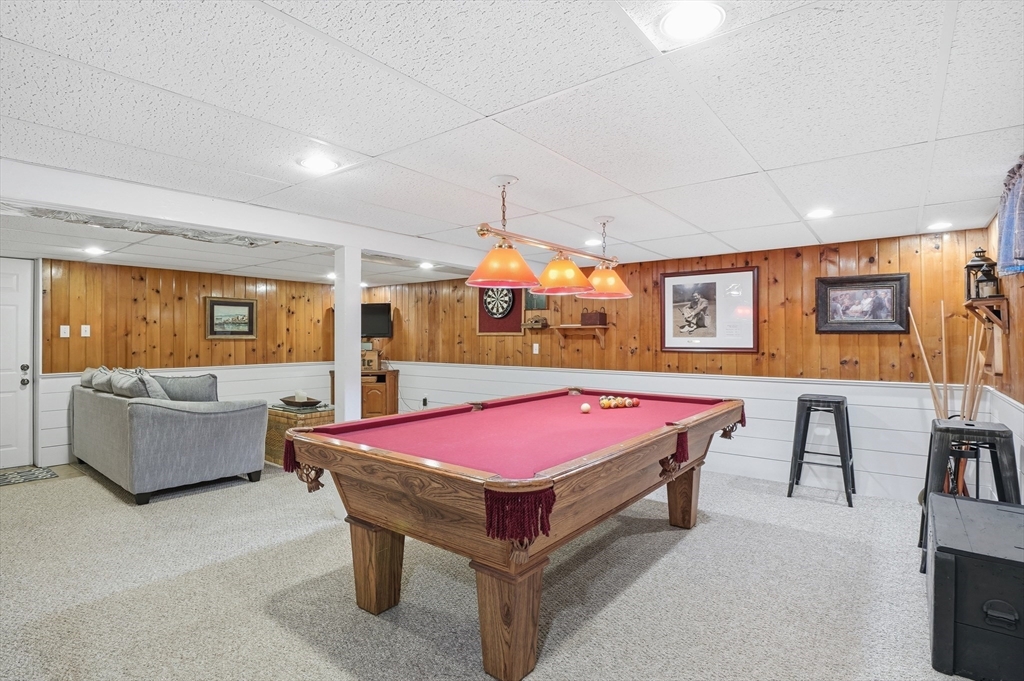 28 Sylvester Road Natick, MA 01760 - Photo 26 of 30 a living room with a couch and a flat screen tv