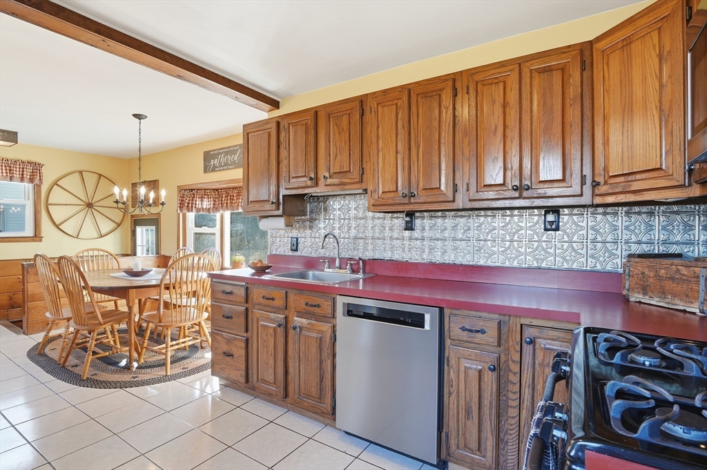28 Sylvester Road Natick, MA 01760 - Photo 8 of 30 a kitchen with a stove a sink and cabinets