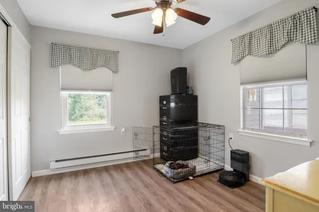 a living room with hard wood floors and a window