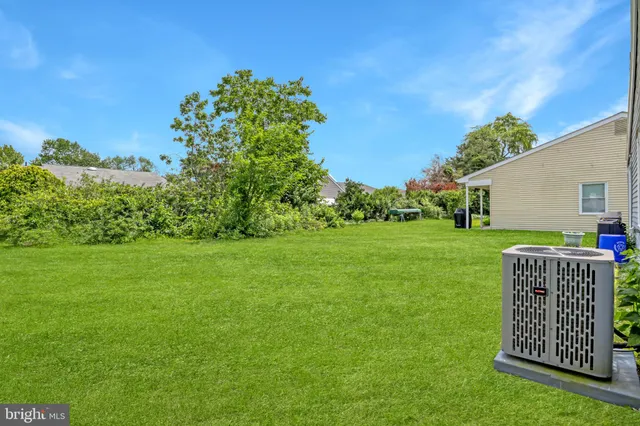a view of an house with backyard space and garden