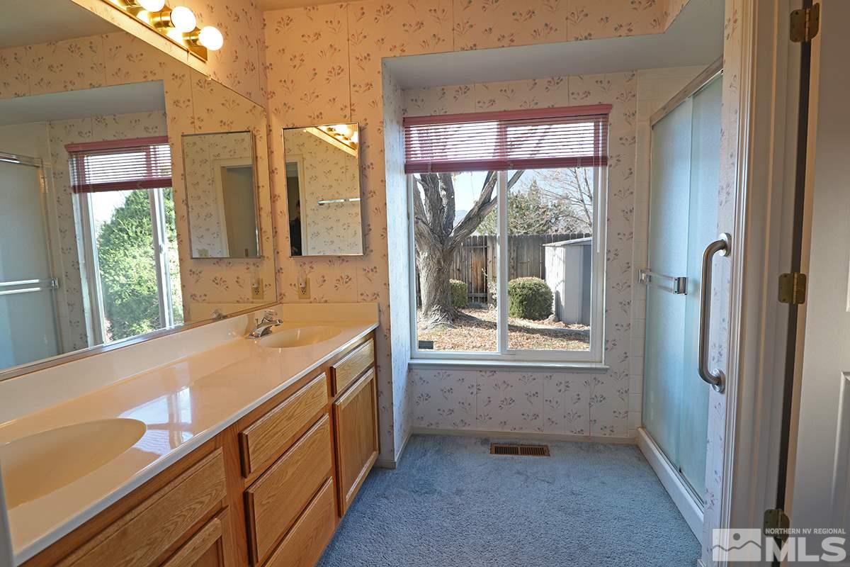 1865 Quail Run Road Reno, NV 89523 - Photo 8 of 25 a bathroom with a tub sink and mirror