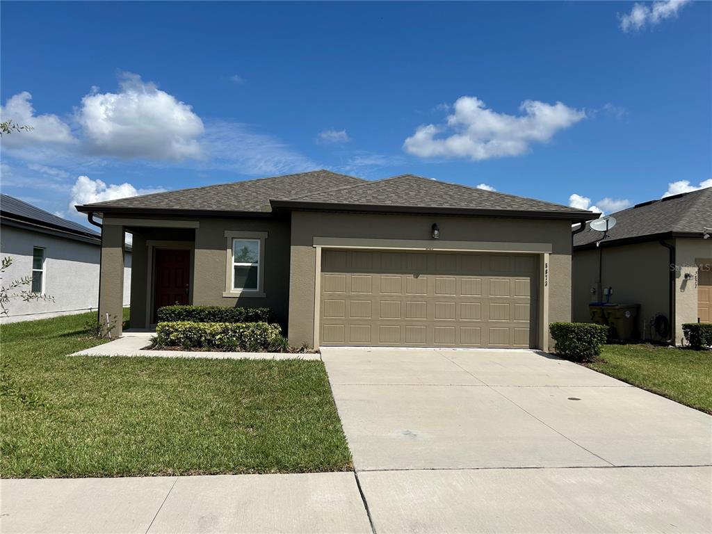 a front view of a house with a yard and garage