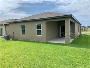 5873 Beefmaster Road St. Cloud, FL 34771 - Photo 13 of 16 a backyard of a house with lots of green space