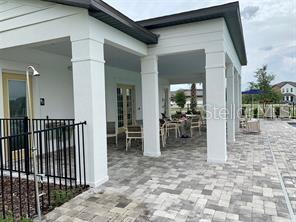 5873 Beefmaster Road St. Cloud, FL 34771 - Photo 16 of 16 a view of a porch with table and chairs