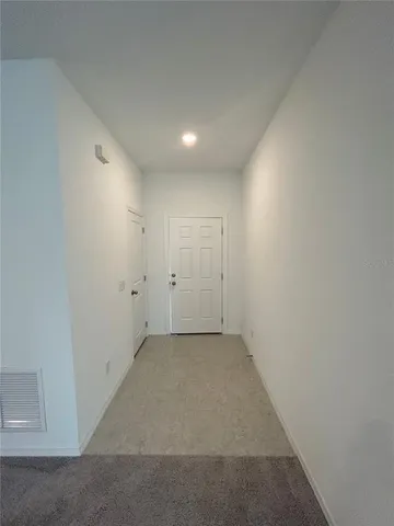a view of kitchen with kitchen island and stainless steel appliances