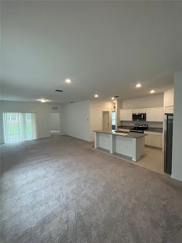 a kitchen with stainless steel appliances granite countertop a sink a stove and a refrigerator