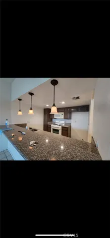 a view of kitchen island with granite countertop