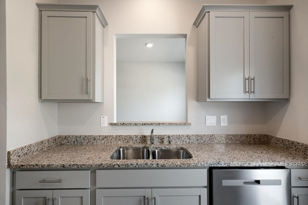 115 Starlight Street Sanford, NC 27330 - Photo 11 of 37 a kitchen with granite countertop white cabinets and a sink