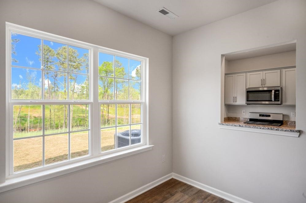 115 Starlight Street Sanford, NC 27330 - Photo 12 of 37 a view of a kitchen with an empty room and a window
