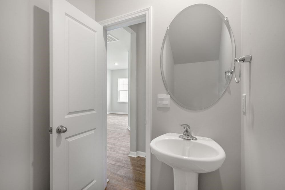 115 Starlight Street Sanford, NC 27330 - Photo 13 of 37 a bathroom with a sink and a mirror