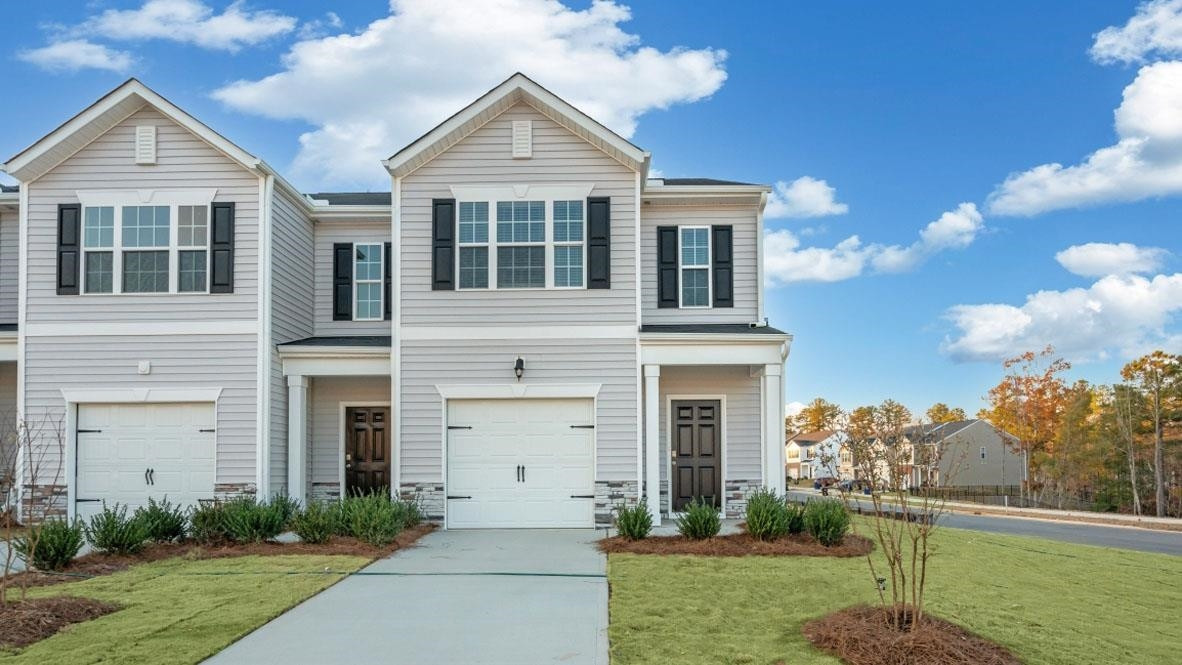 115 Starlight Street Sanford, NC 27330 - Photo 2 of 37 a front view of a house with a yard and garage