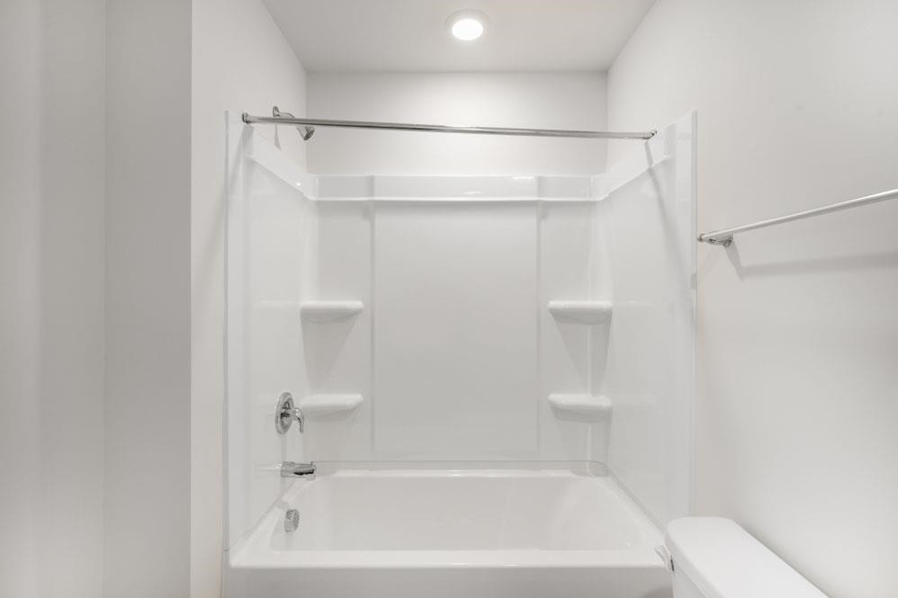 115 Starlight Street Sanford, NC 27330 - Photo 28 of 37 a bathroom with a shower and a bath tub