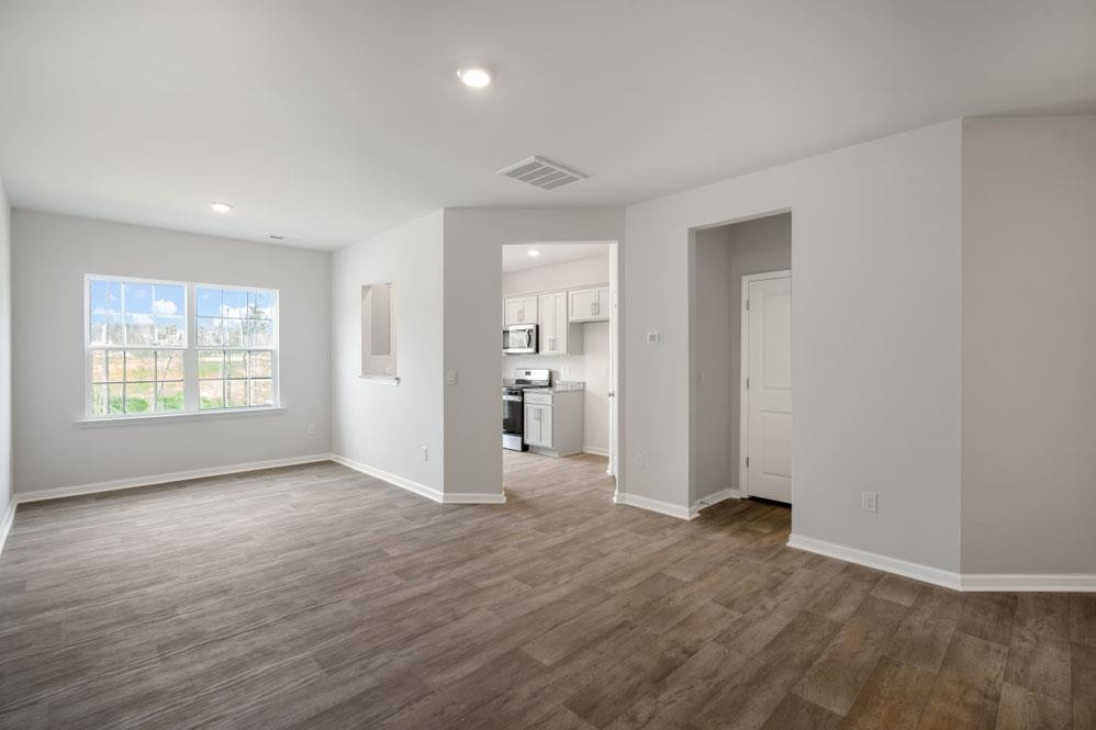 115 Starlight Street Sanford, NC 27330 - Photo 7 of 37 an empty room with wooden floor and windows