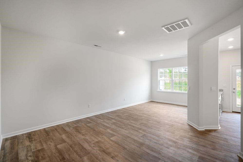 115 Starlight Street Sanford, NC 27330 - Photo 8 of 37 wooden floor in an empty room with a window