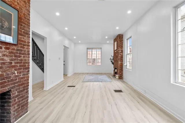 a view of entryway with wooden floor and stairs