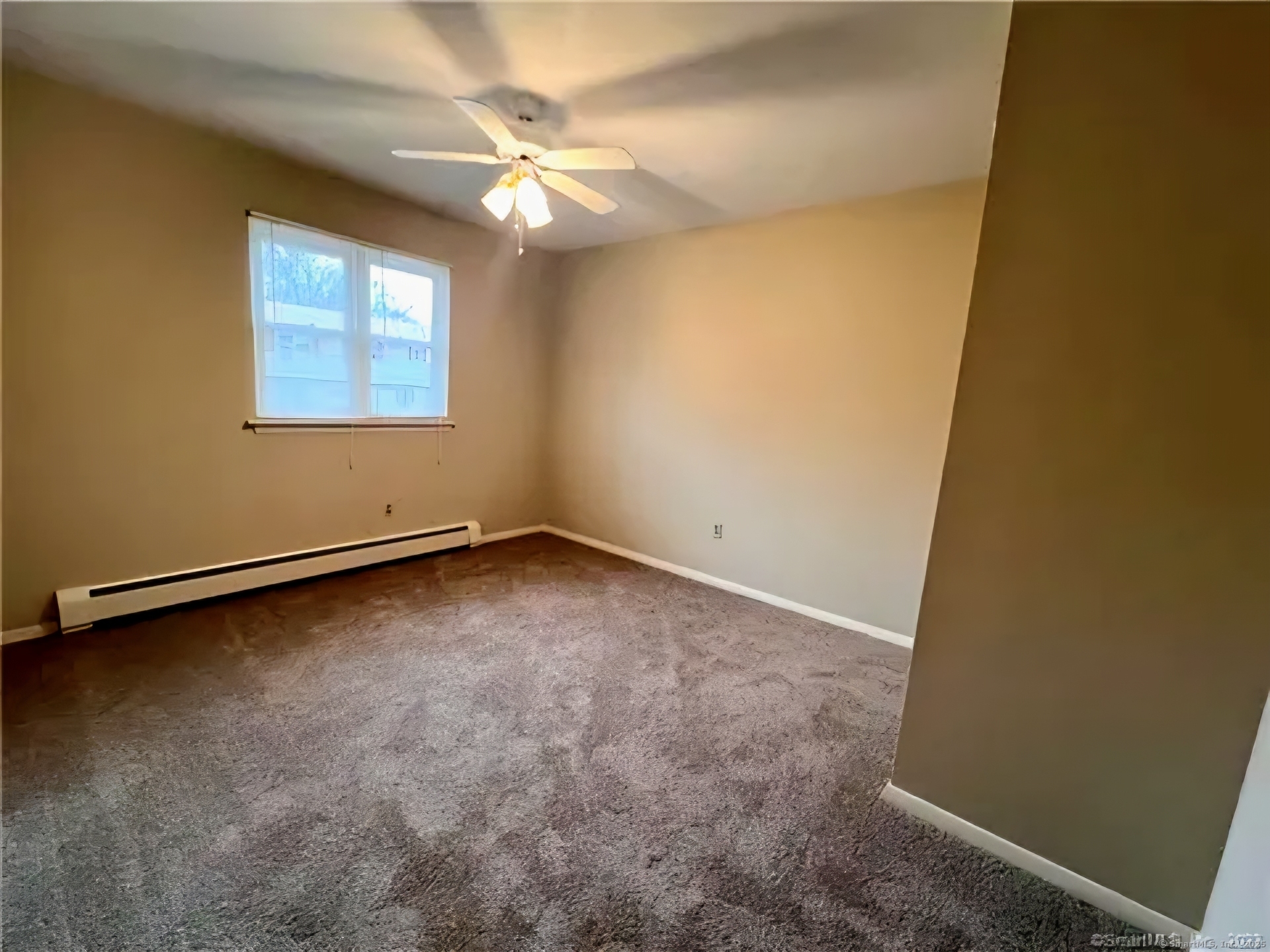 33 Ridge Road, Unit 2 Naugatuck, CT 06770 - Photo 9 of 11 an empty room with a chandelier fan and a window