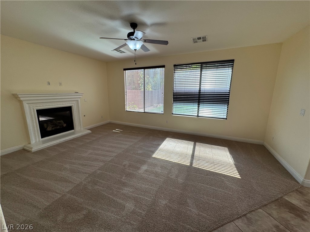 1333 Jamesbury Road Las Vegas, NV 89135 - Photo 13 of 43 A comforting fireplace forms the centerpiece of this inviting carpeted living area.