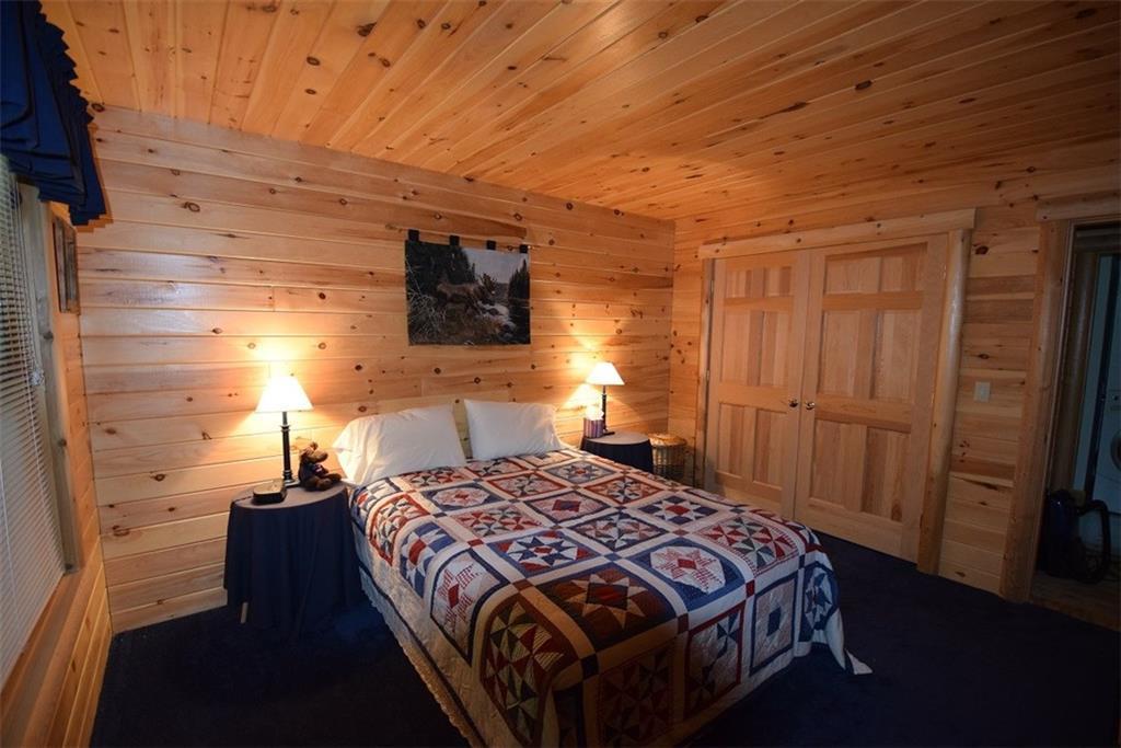 85 Gardner Point Road Mount Chase, ME 04765 - Photo 15 of 35 First level master bedroom with...