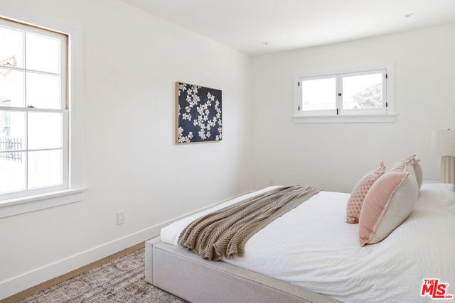 a bedroom with a bed and a table in it