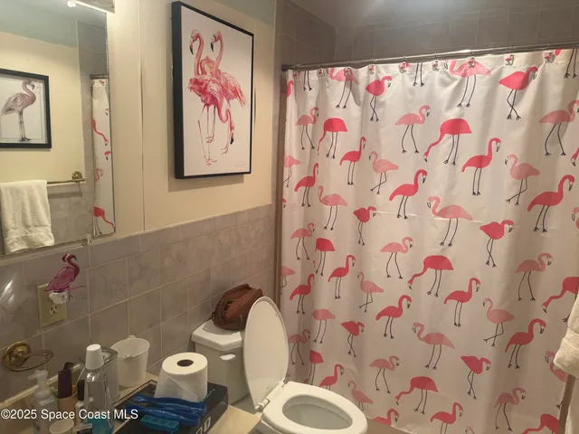 a bathroom with a sink toilet and a shower curtain