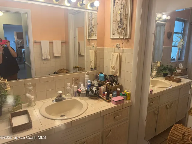 a bathroom with a sink double vanity and a mirror