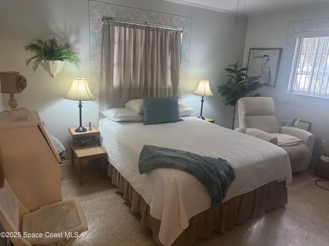 a bedroom with double bed and a lamp