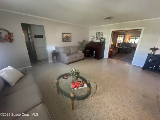 a living room with furniture and a mirror