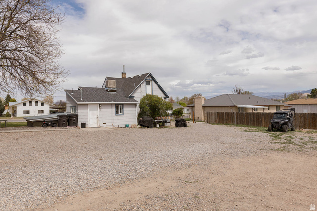 197 West 100 South Redmond, UT 84652 - Photo 23 of 41 Rear view of house with a chimney and a residential view
