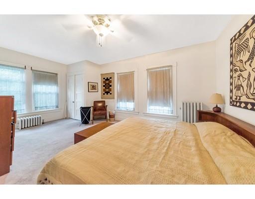 18 Washington Road Springfield, MA 01108 - Photo 11 of 22 a bedroom with a large bed and a chandelier