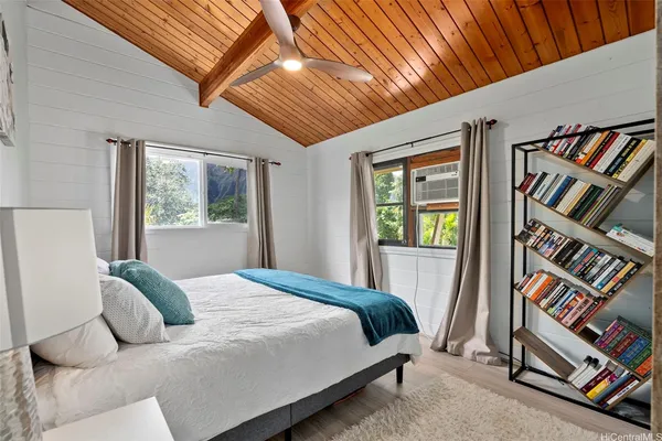 a bedroom with a bed and a window