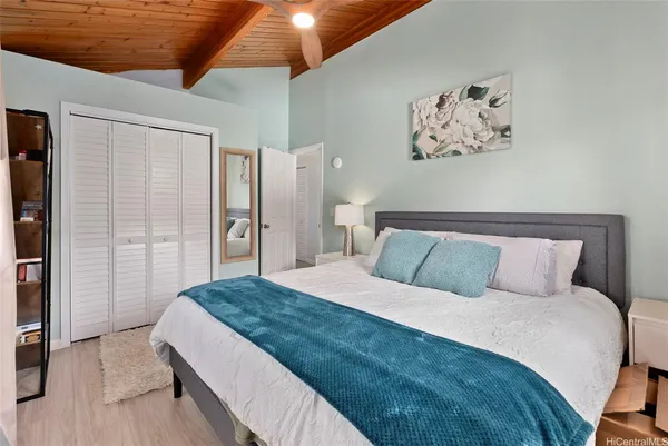 a bedroom with a large bed and a chandelier