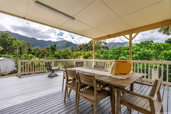 a view of a chairs and table on the wooden deck