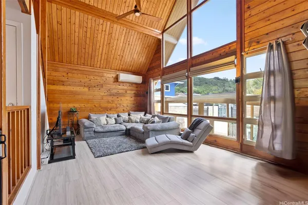 a living room with furniture and a floor to ceiling window