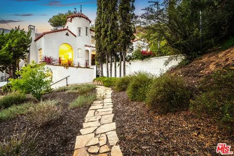 a living room with furniture a fireplace and a chandelier