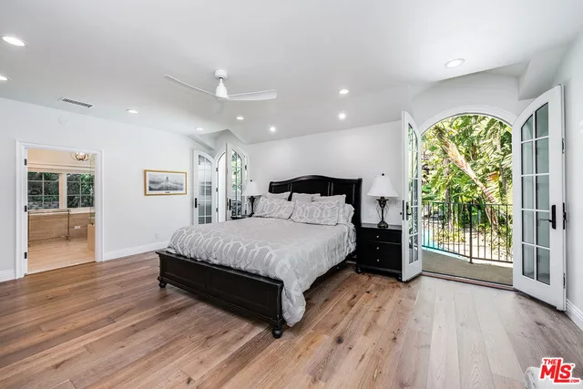 a spacious bedroom with a bed and a large window