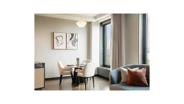 a living room with furniture and a potted plant