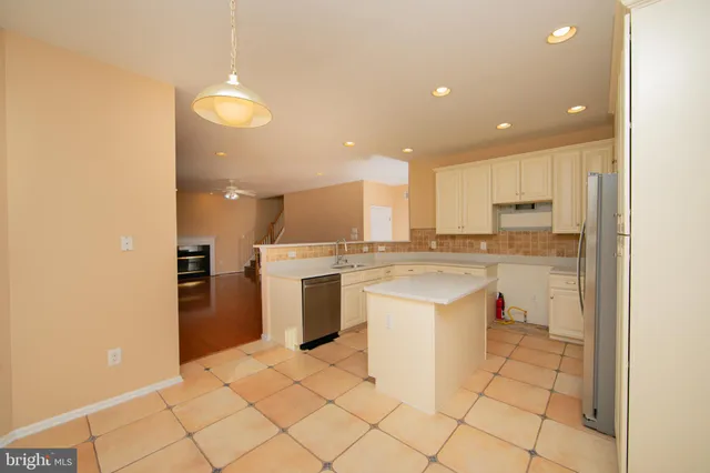 a kitchen with a sink a counter top space and appliances