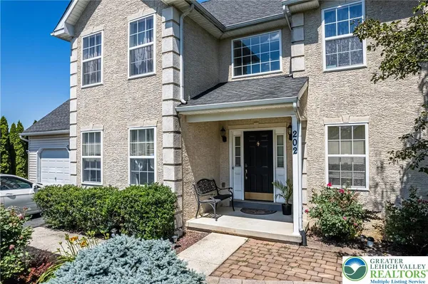 front view of a brick house with a small yard