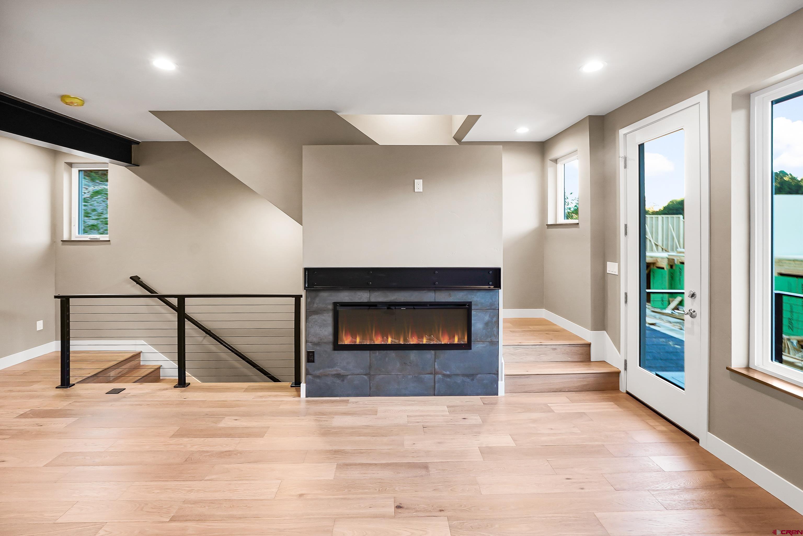 760 Goeglein Gulch Road, Unit 3 Durango, CO 81301 - Photo 6 of 40 a living room with a fireplace and a floor to ceiling window