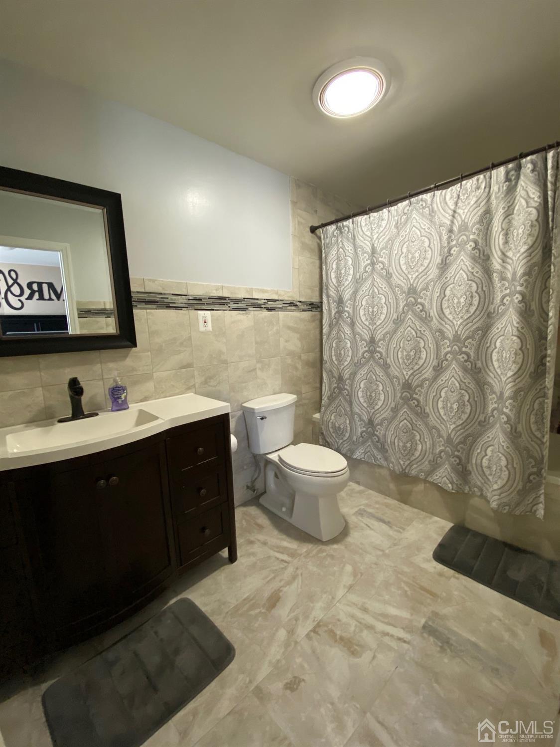 29 Longfield Road New Brunswick, NJ 08901 - Photo 17 of 25 a spacious bathroom with a double vanity sink toilet and a mirror