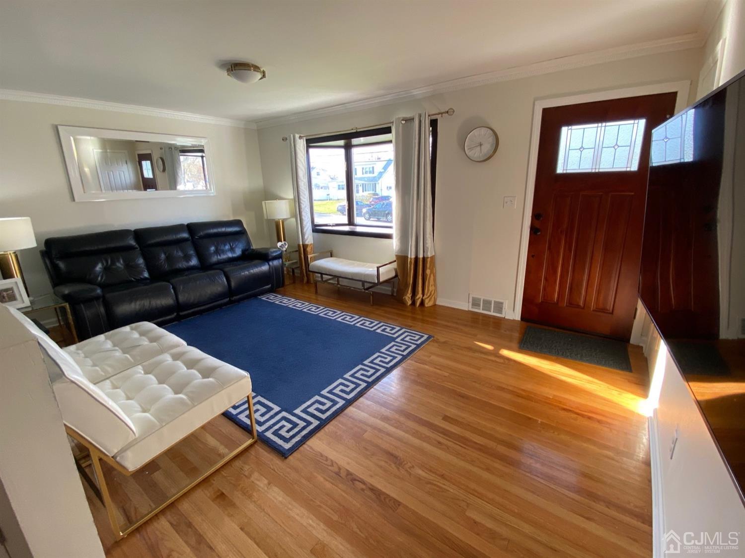 29 Longfield Road New Brunswick, NJ 08901 - Photo 7 of 25 a living room with a couch and two windows