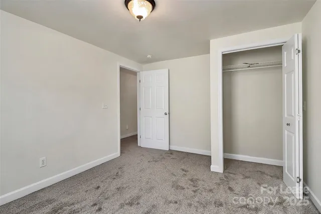 a view of a livingroom with wooden floor and window